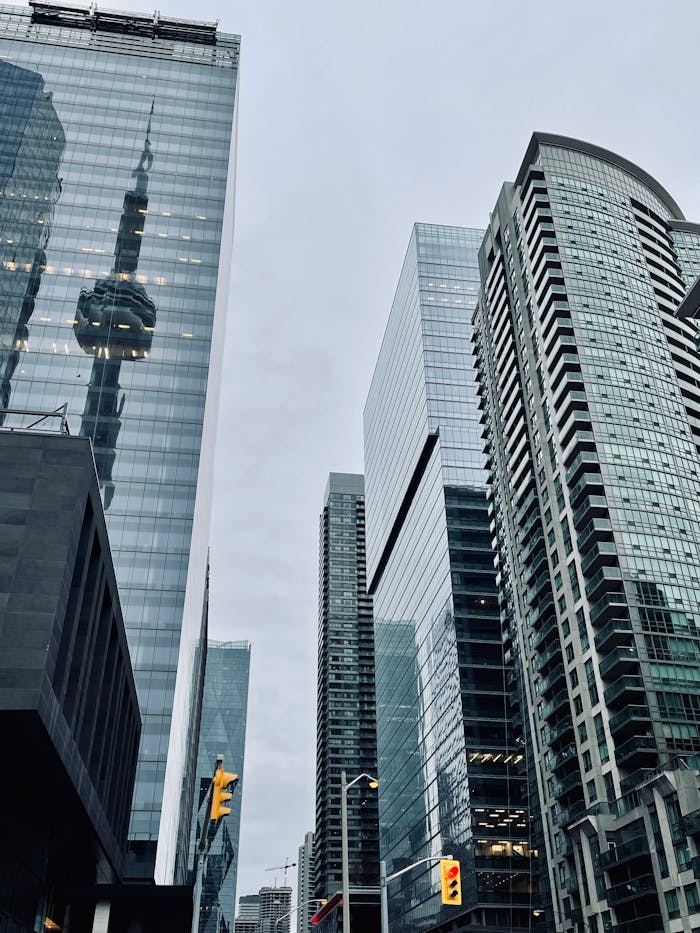 gallery-1 Low angle shot of skyscrapers with CN Tower reflection in Toronto's financial district.
